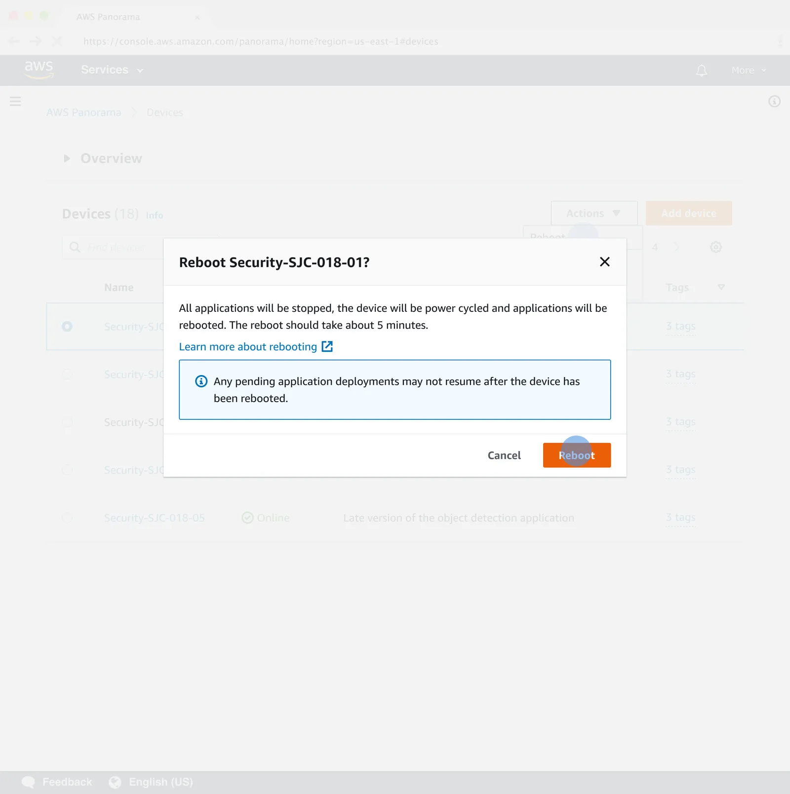 Reboot confirmation dialog for device Security-SJC-018-01, stating that all applications will be stopped and the device power cycled, that the reboot takes about five minutes, and warning that pending application deployments may not resume